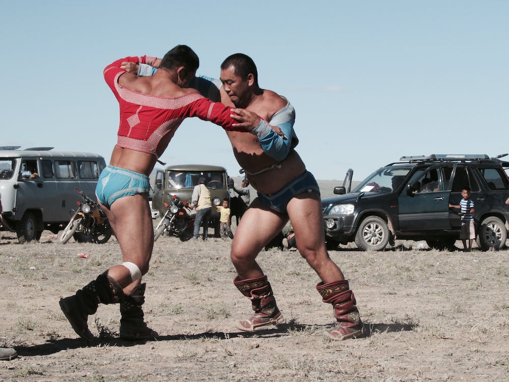 Two wrestlers in open air combat